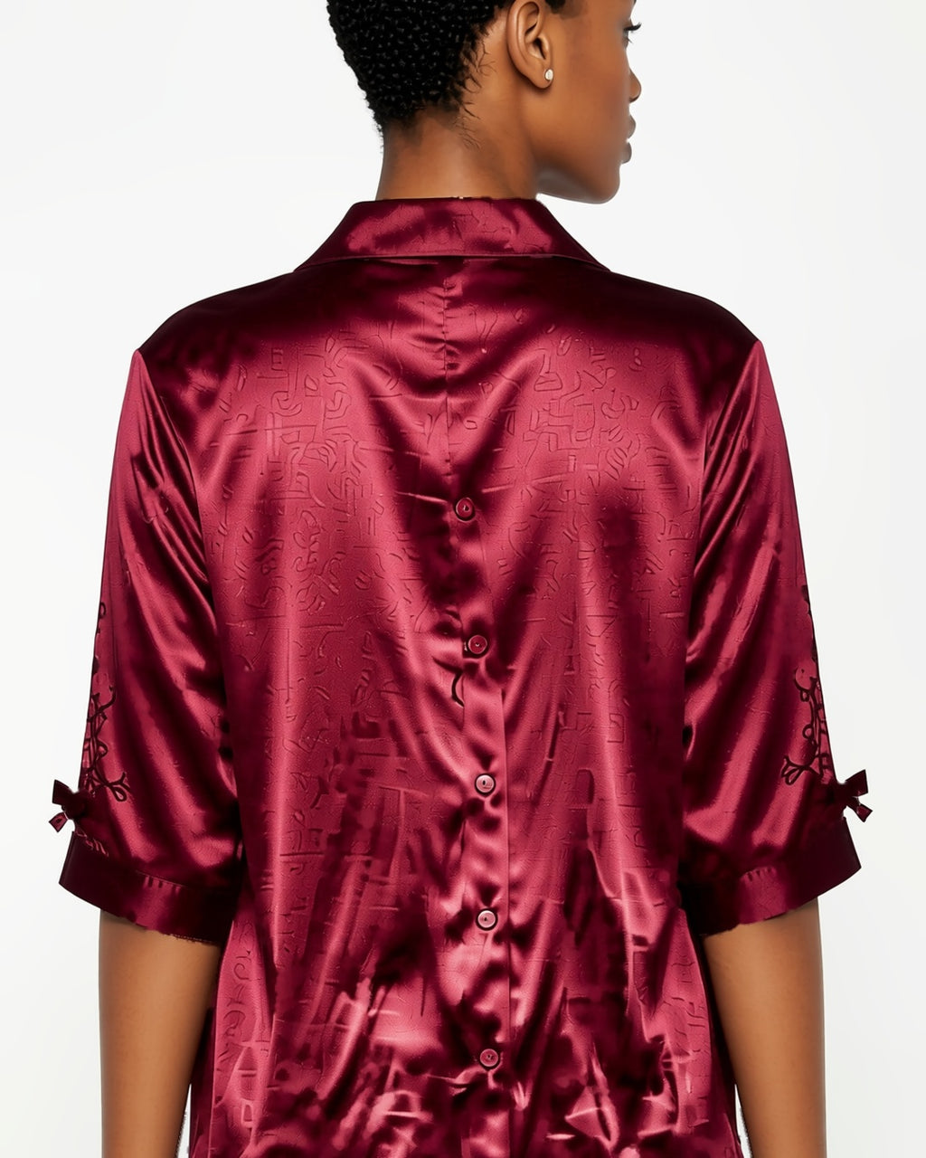 Satin Button-Up Sleep Shirt Dress in Red, detail close-up of the back of the shirt dress: the collar and the half sleeves. onmodel