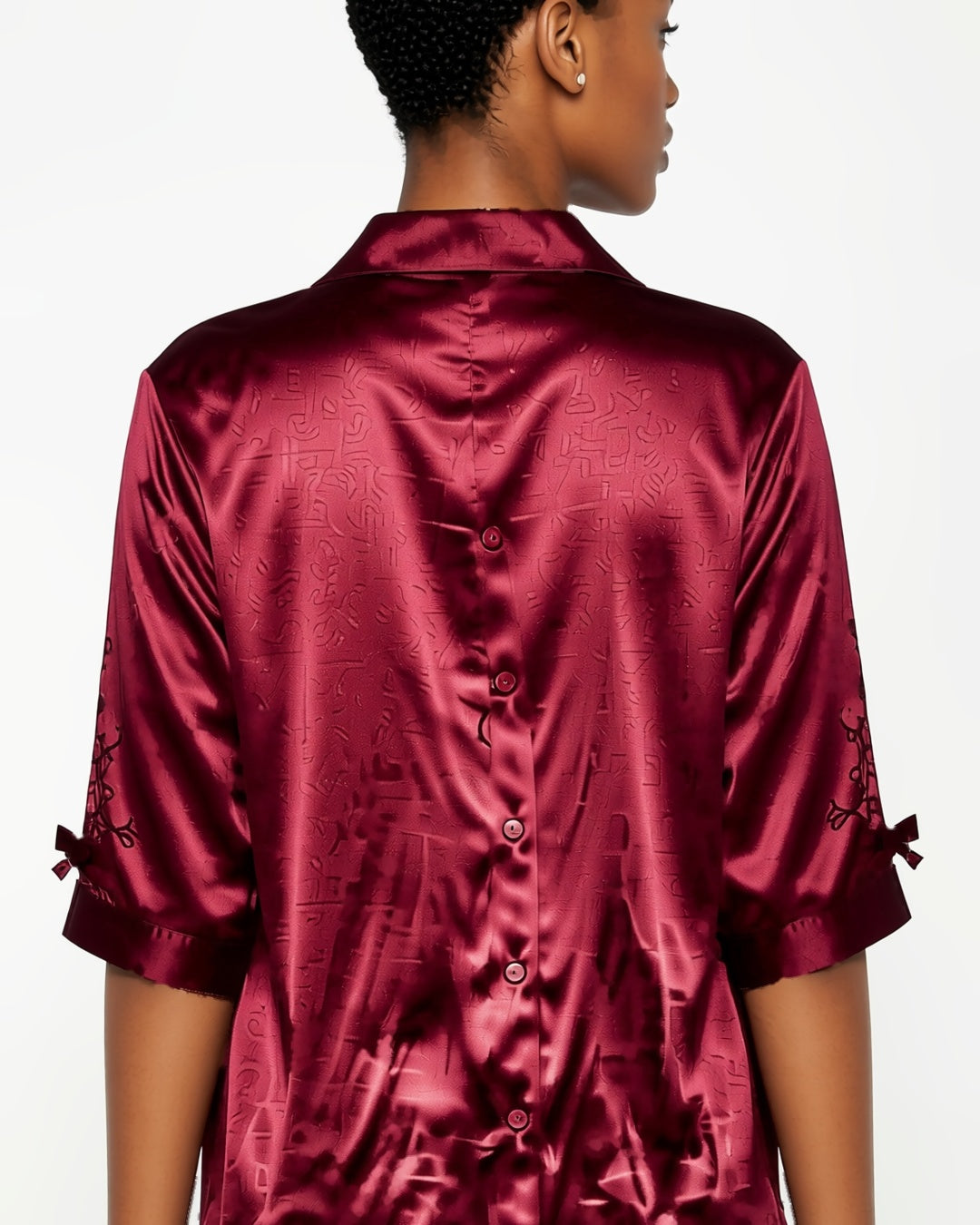 Satin Button-Up Sleep Shirt Dress in Red, detail close-up of the back of the shirt dress: the collar and the half sleeves. onmodel