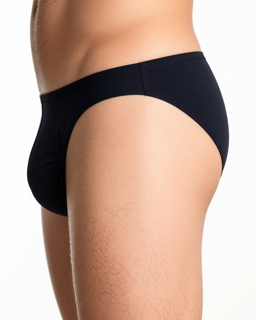 Men's Sheer Low-Rise Briefs in Black, detail close-up of the waistband and the side seam of the brief at the hip. onmodel