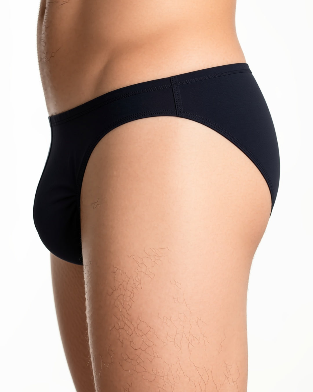 Men's Sheer Low-Rise Briefs in Black, detail close-up of the waistband and the side seam of the brief at the hip. onmodel