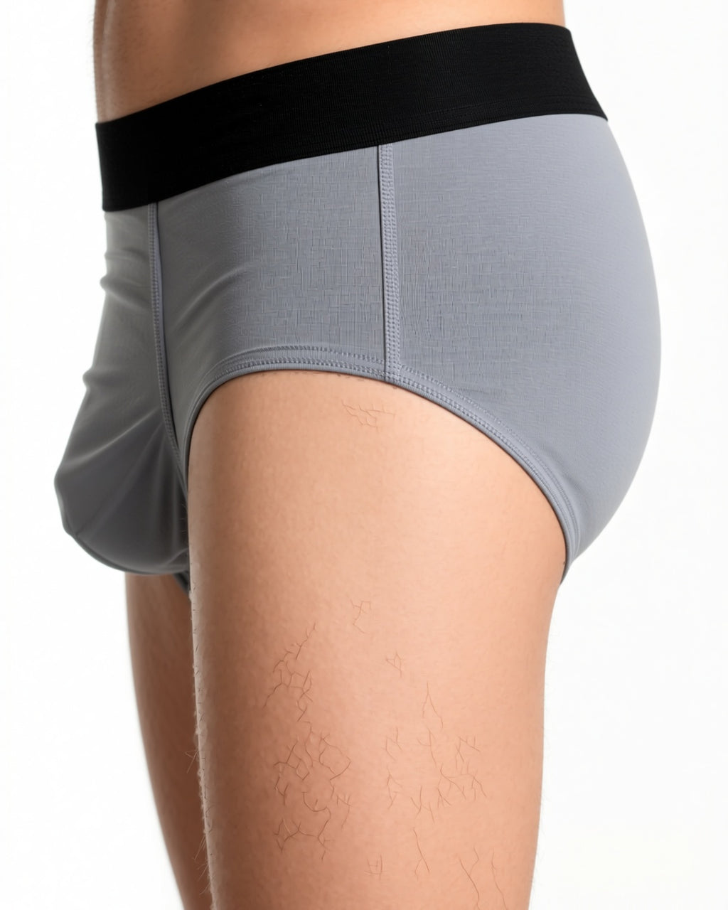 Men's Ultra-Thin Low-Rise Briefs with 3D Pouch in Grey, detail close-up of the waistband and the side seam of the brief at the hip. onmodel