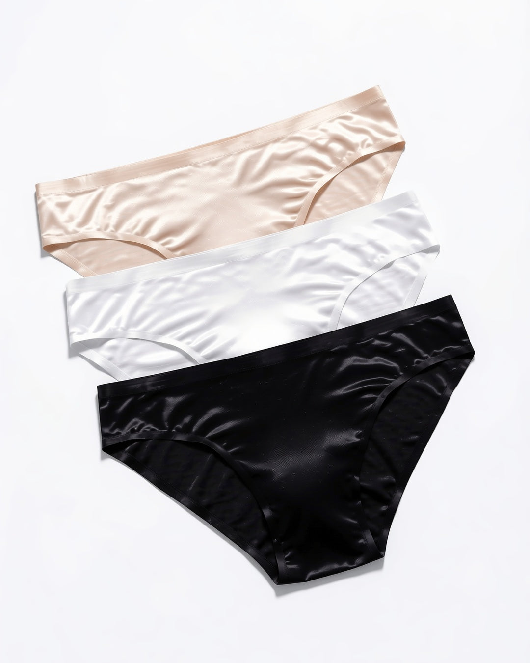 Men's Seamless Low-Rise Briefs, 3-Pack in Light Beige, White, Black, laid flat to show the full piece.
