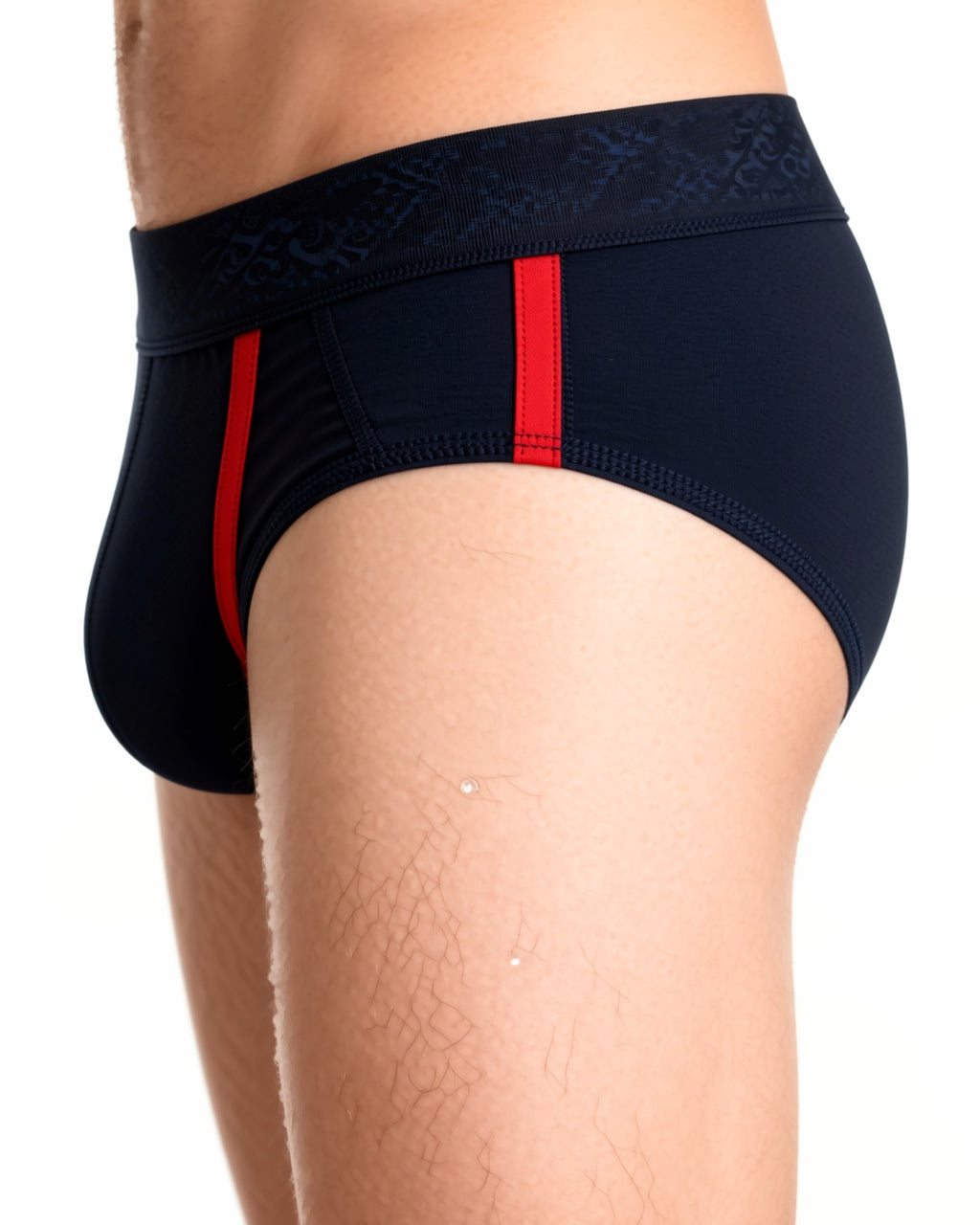 Men's Front-Opening Low-Rise Briefs in Black With Red Piping, detail close-up of the waistband and the side seam of the brief at the hip. onmodel