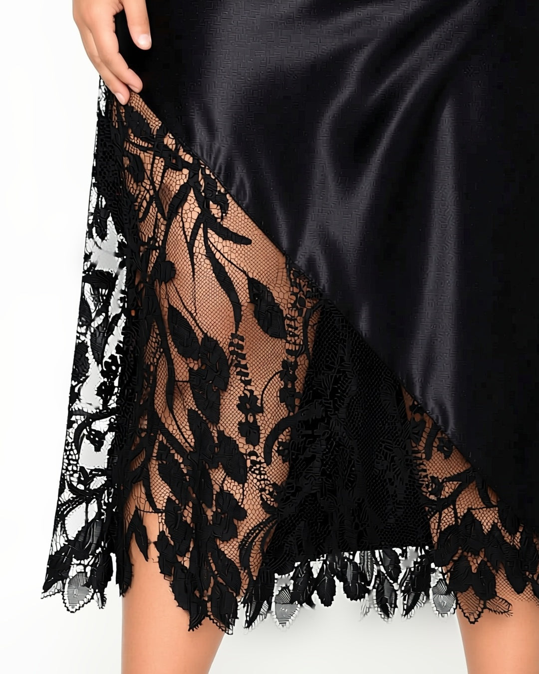 Plus Size Long Satin Slip with Lace Hem in Black, detail close-up of the lace panel at the hem. onmodel