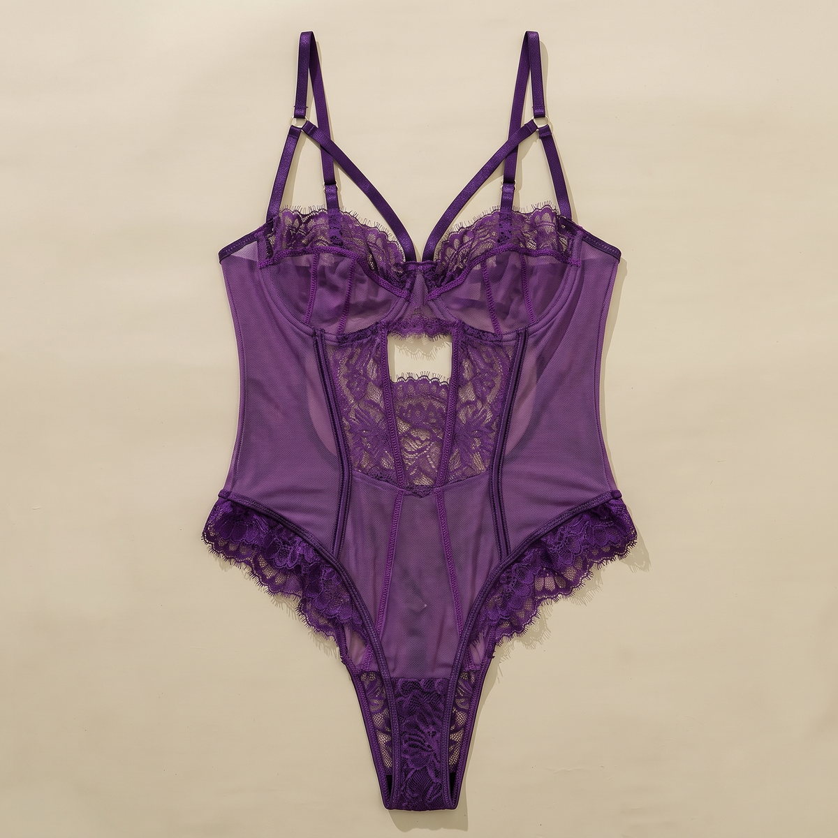 Deep purple lace bodysuit with mesh cups and high-cut lace legs laid flat