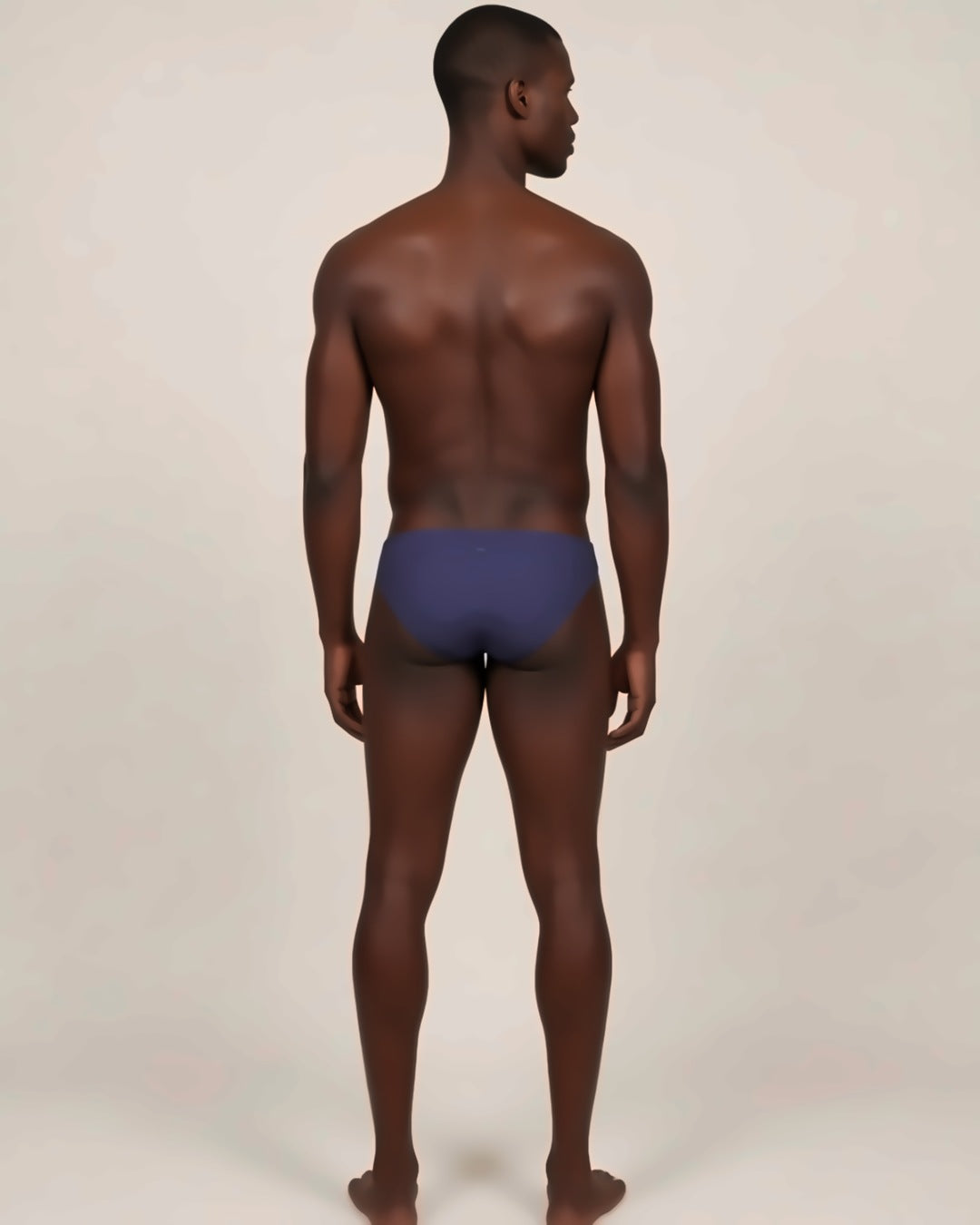 Men's Cheeky Low-Rise Bikini Briefs in navy, back view on a model.