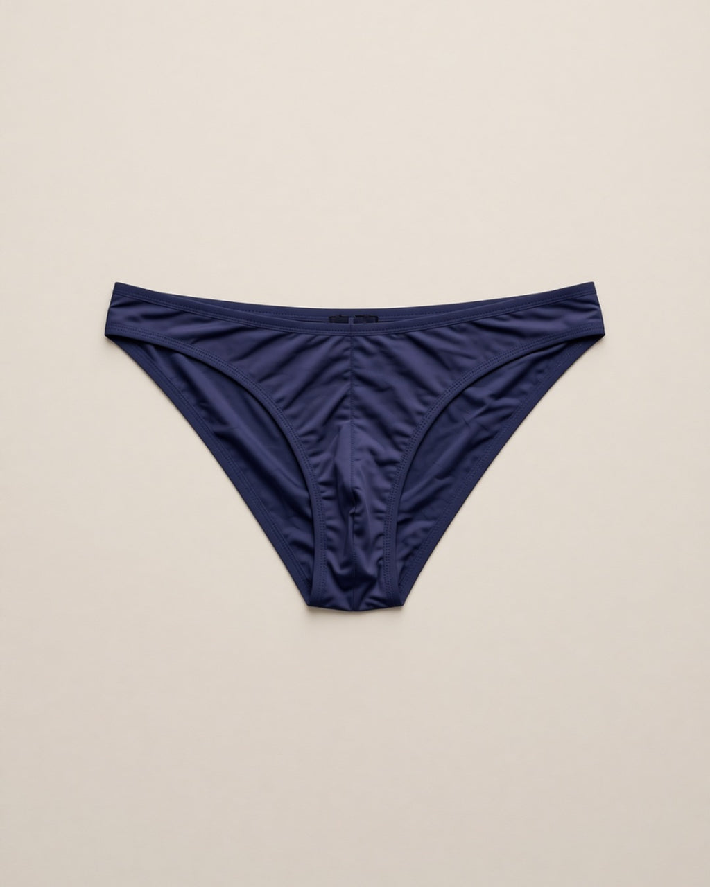 Men's Cheeky Low-Rise Bikini Briefs, laid flat to show the full piece.