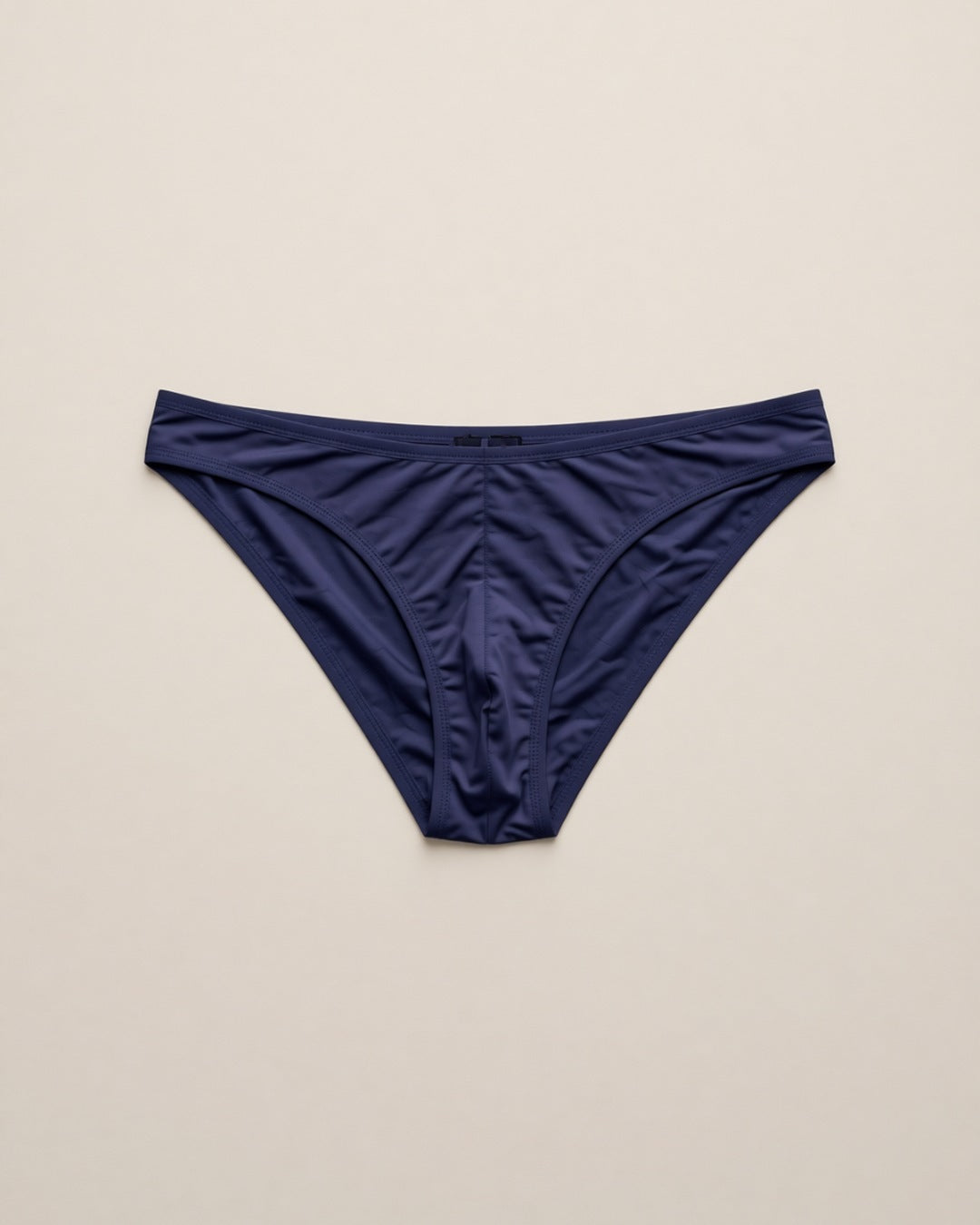 Men's Cheeky Low-Rise Bikini Briefs, laid flat to show the full piece.
