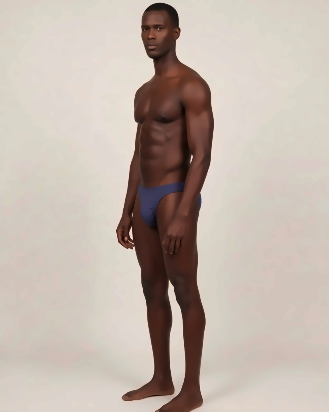 Men's Cheeky Low-Rise Bikini Briefs in navy, three-quarter view on a model.