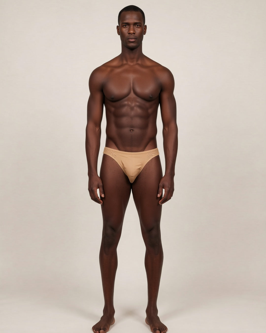 Men's Cheeky Low-Rise Bikini Briefs in nude, front view on a model.