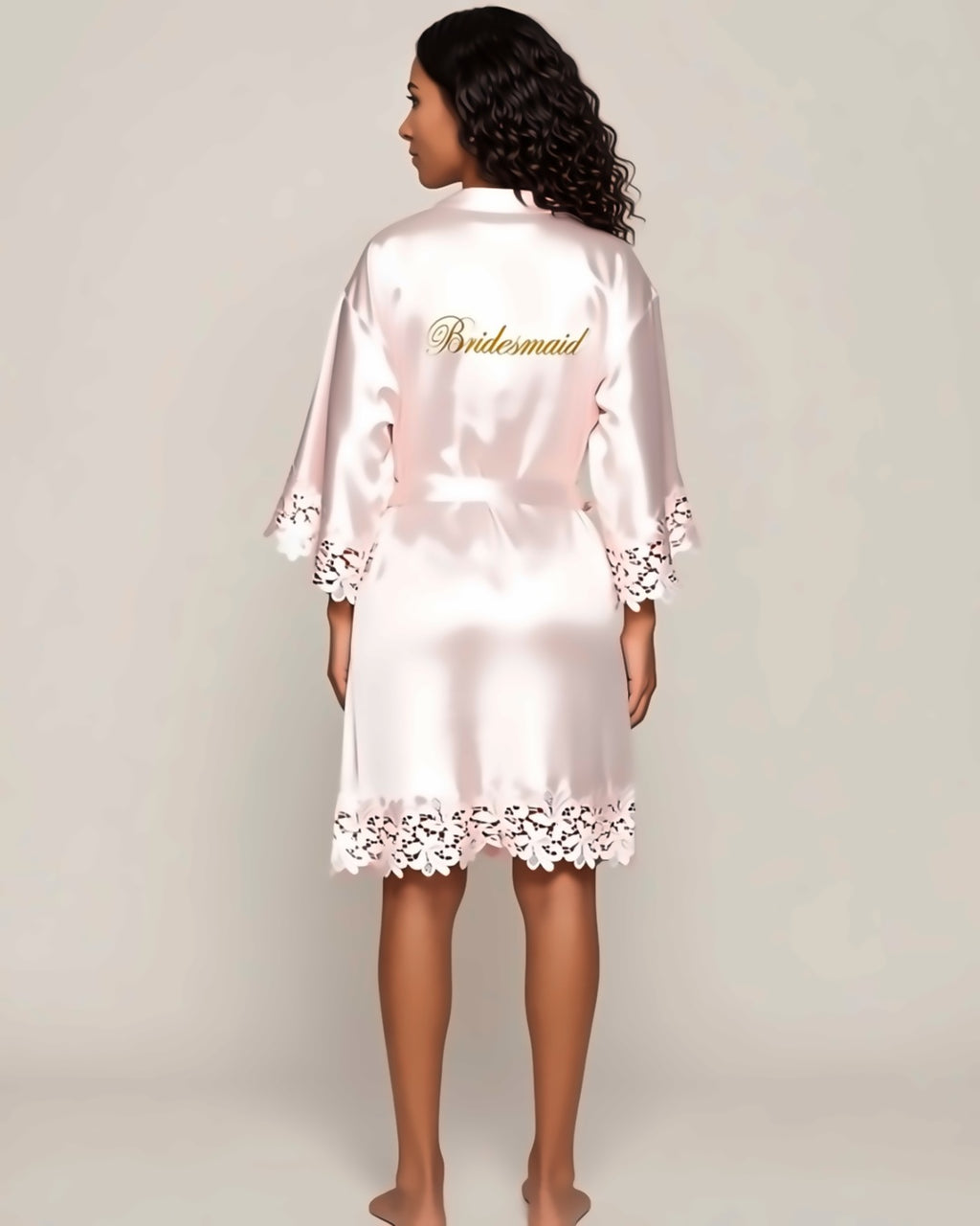 Satin and Lace Bride and Bridesmaid Robe in pink, back view on a model. Pieces other than the robe are styling only.