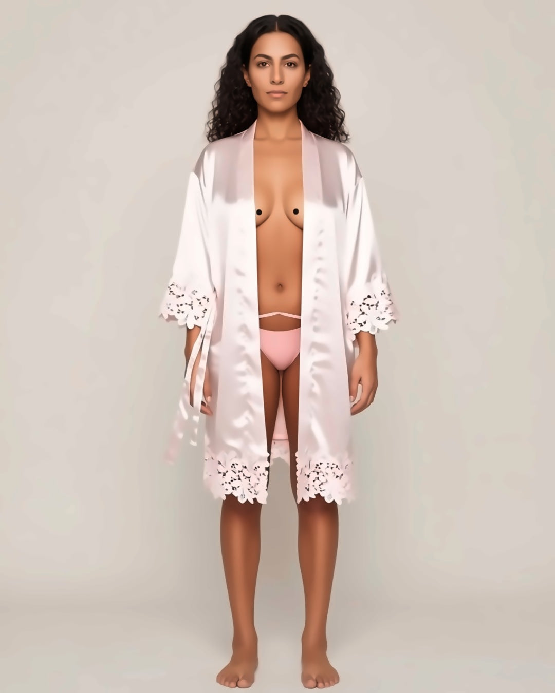 Satin and Lace Bride and Bridesmaid Robe in pink, front view on a model. Pieces other than the robe are styling only.