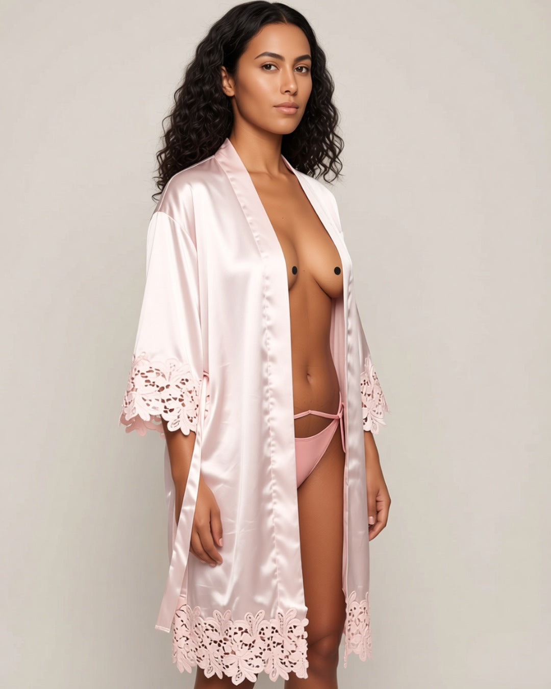 Satin and Lace Bride and Bridesmaid Robe in pink, three-quarter view on a model. Pieces other than the robe are styling only.